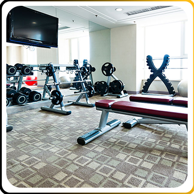 A hotel gym with weights and benches