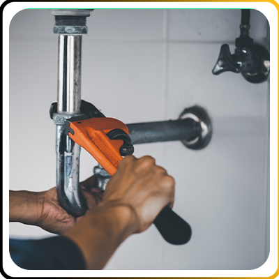 A plumber working on some pipes