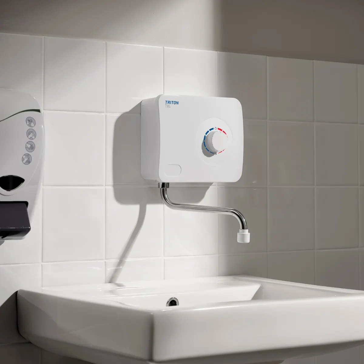 Instantaneous water heater above a bathroom basin